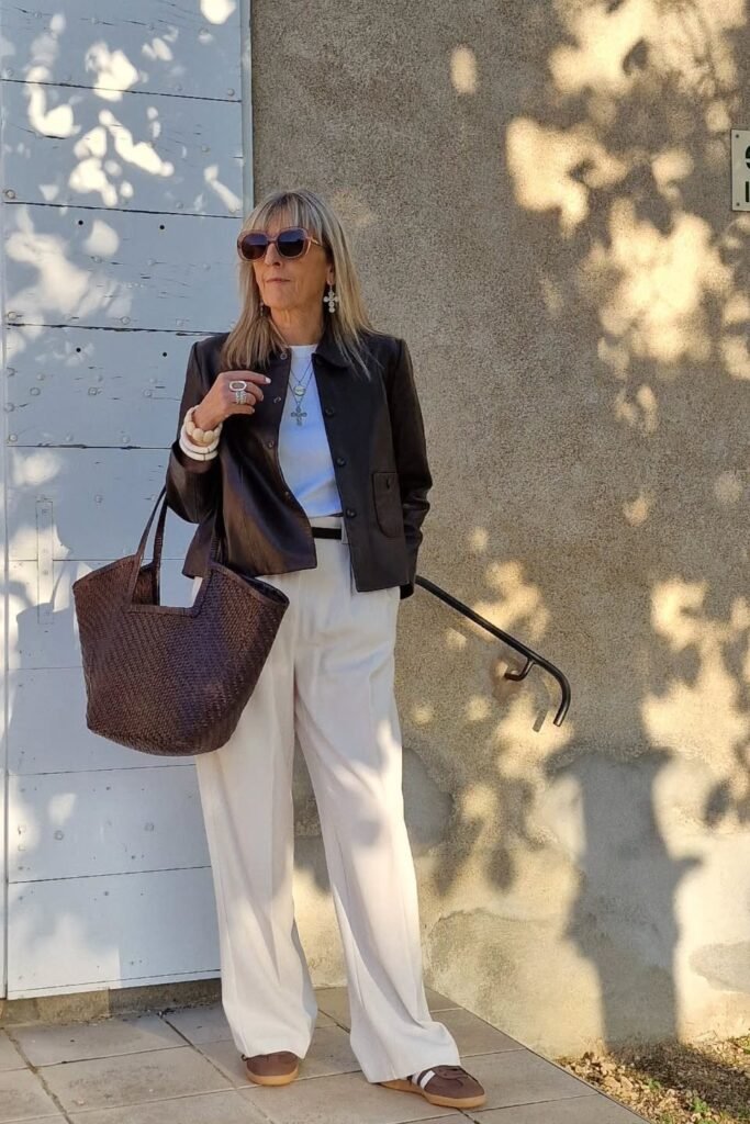 Dark Brown Leather Jacket + White T-Shirt + Off-White Wide-Leg Trousers + Brown Sneakers