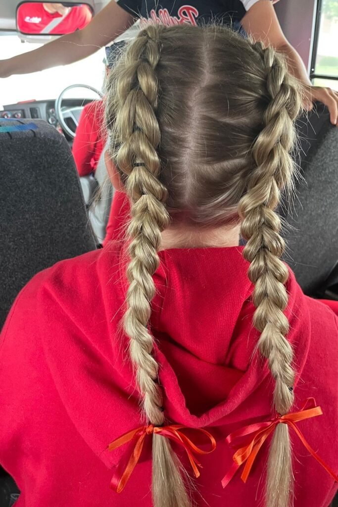 Dutch Braided Pigtails with Red Ribbon Accents