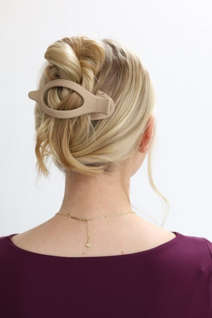 Effortless Twisted Updo with Oval Beige Hair Accessory