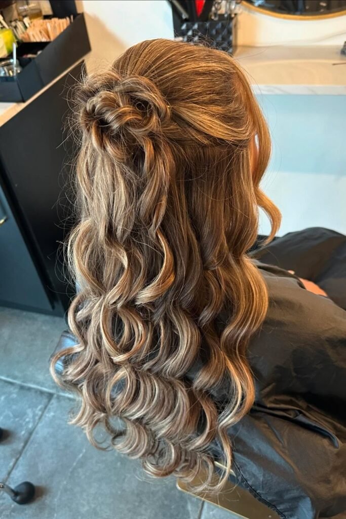 Floral Rose Bun Half-Updo with Polished Golden Blonde Waves