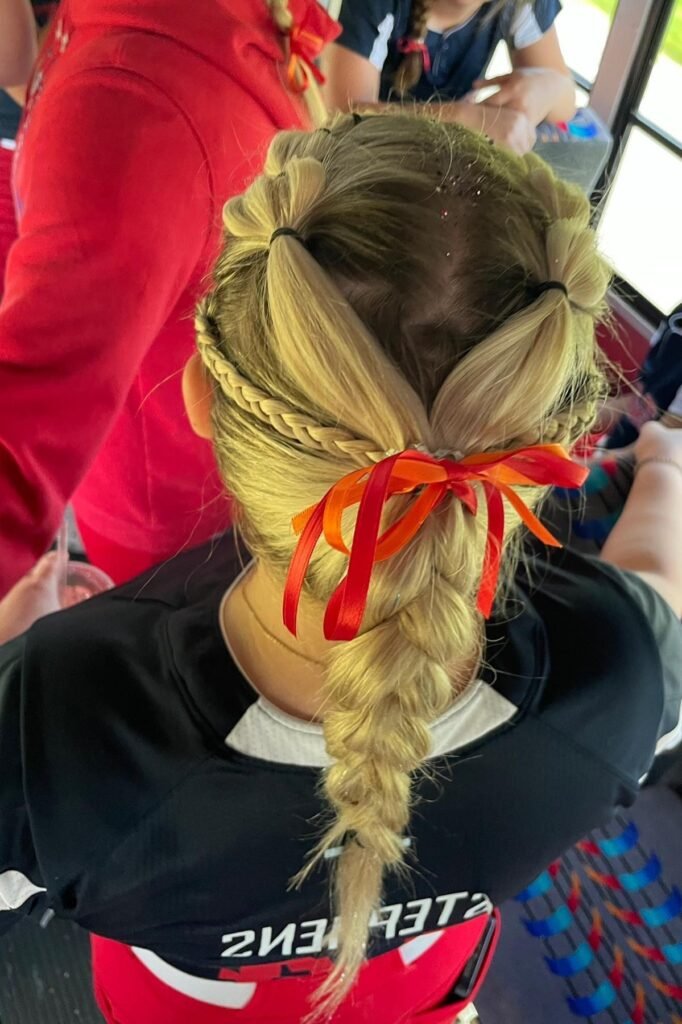 French Braid and Pigtail Hybrid with Orange and Red Ribbons