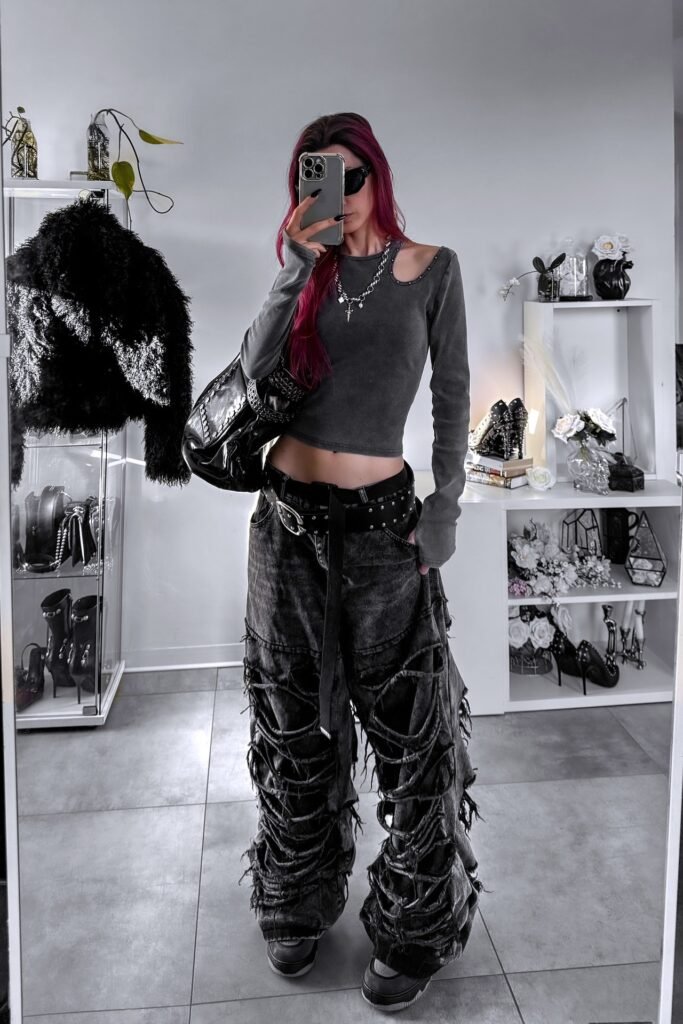 Grey Cut-out Shoulder Long-sleeve Top + Heavily Distressed Black Wide-leg Jeans + Studded Belt + Sneakers