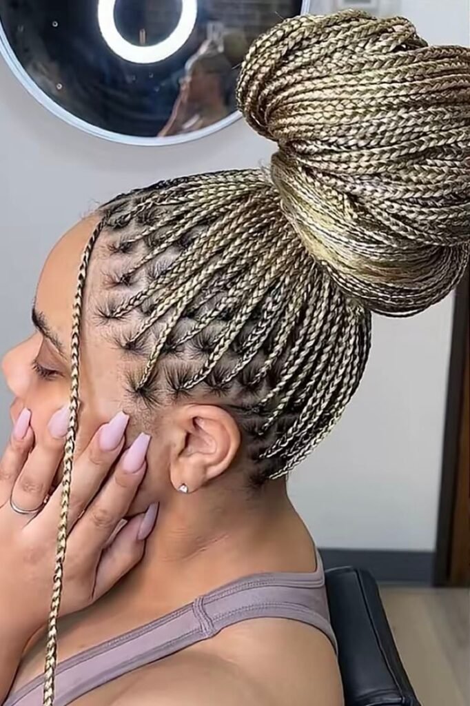 High Braided Top Knot Bun with Single Face-Framing Braid