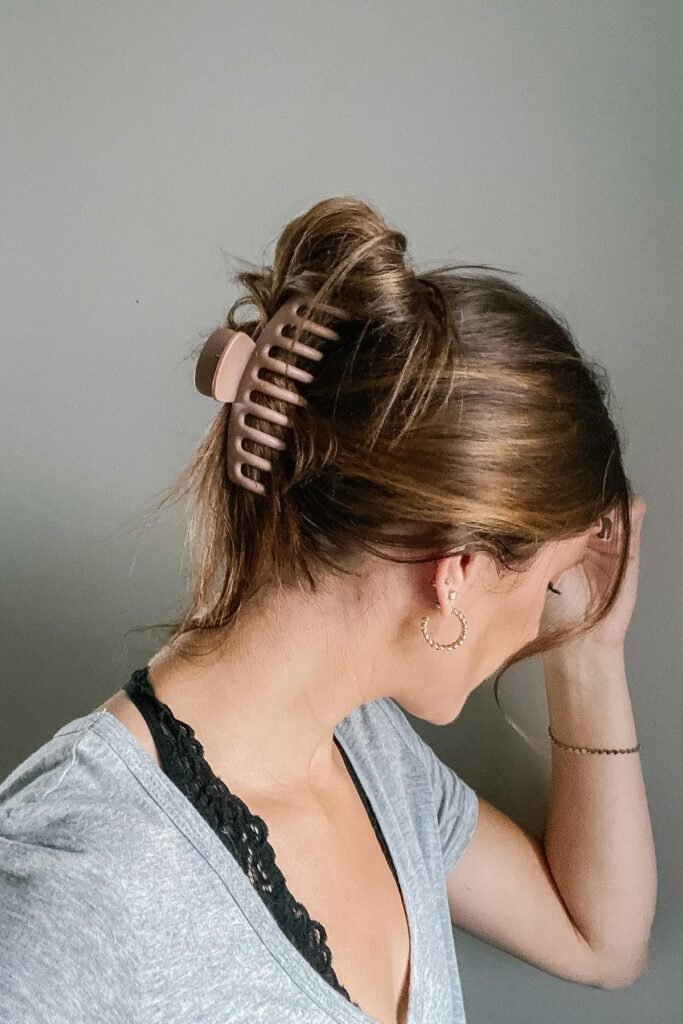 High Messy Bun with Matte Mauve Claw Clip and Textured Strands