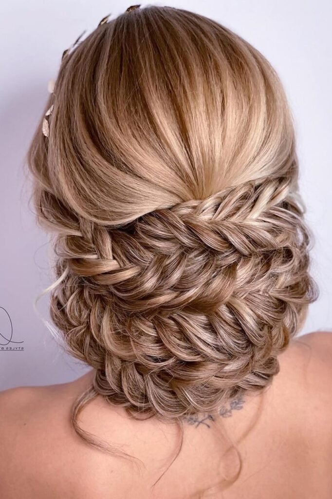 Intricate Fishtail Braid Updo with Leaf Accessory