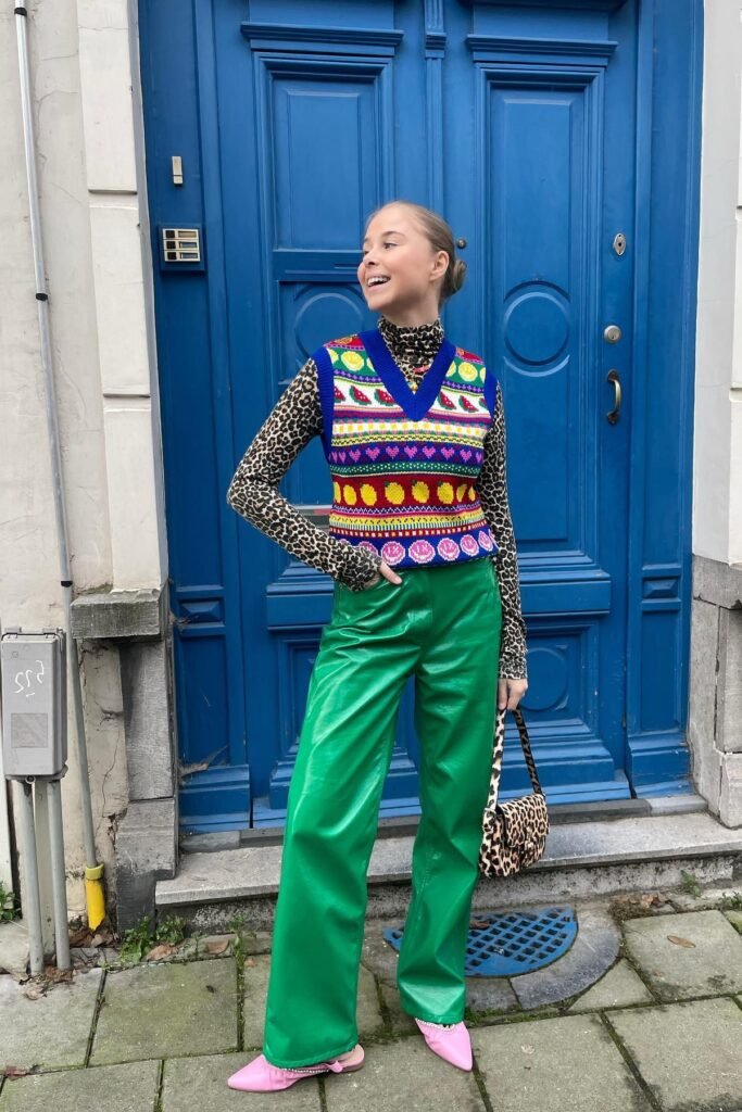 Leopard Print Turtleneck + Colorful Patterned Sweater Vest + Green Leather Trousers + Pink Pointed Flats