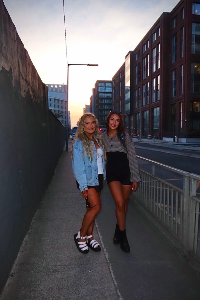 Oversized Denim Jacket + White Crop Top + Black Mini Shorts + White Platform Sandals | Right: Striped Long-Sleeve Crop Top + Black High-Waisted Shorts + Black Leather Boots