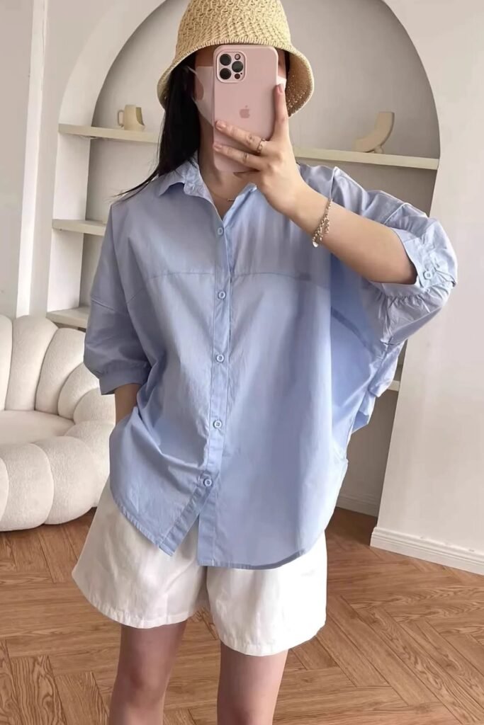 Oversized Light Blue Button-Down + White Cotton Shorts + Straw Bucket Hat