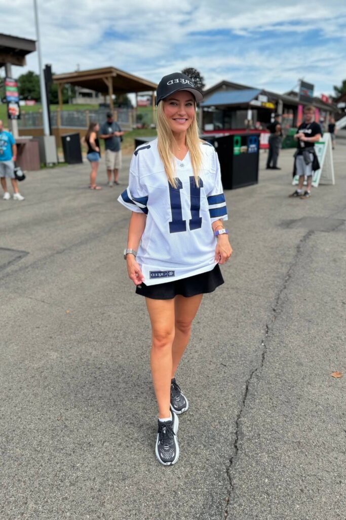 Oversized White Graphic Jersey + Black Mini Skirt + Black and White Sneakers