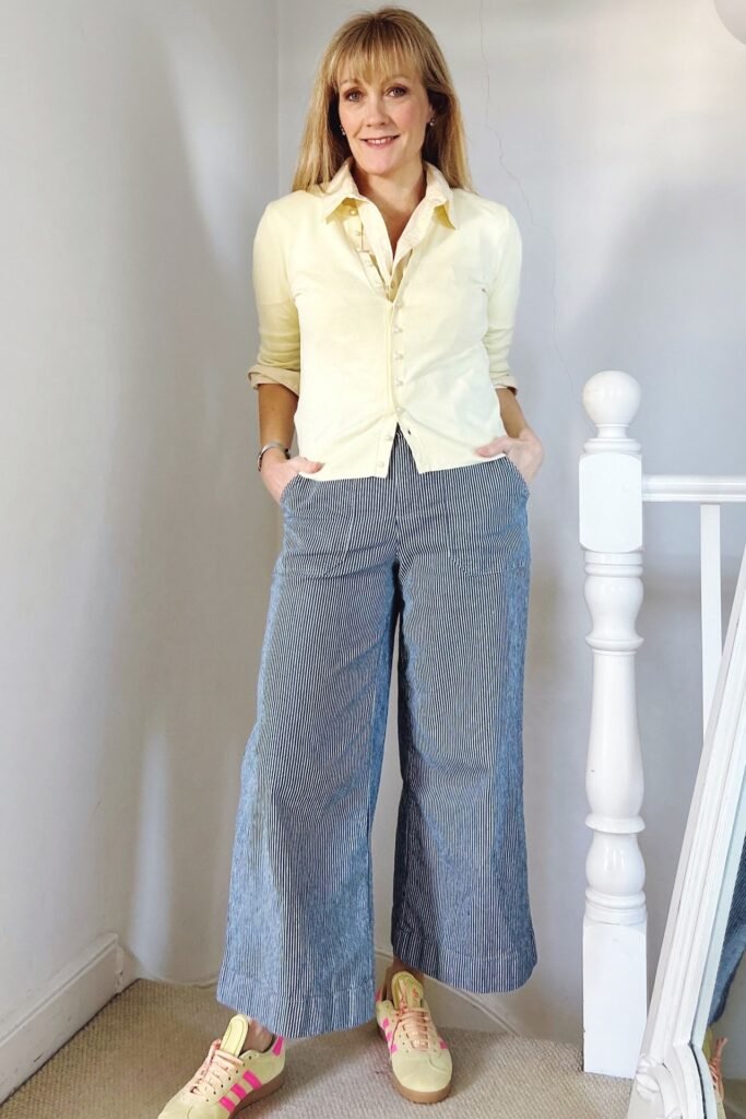 Pale Yellow Cardigan + Vertical Striped Wide-Leg Trousers + Yellow Sneakers