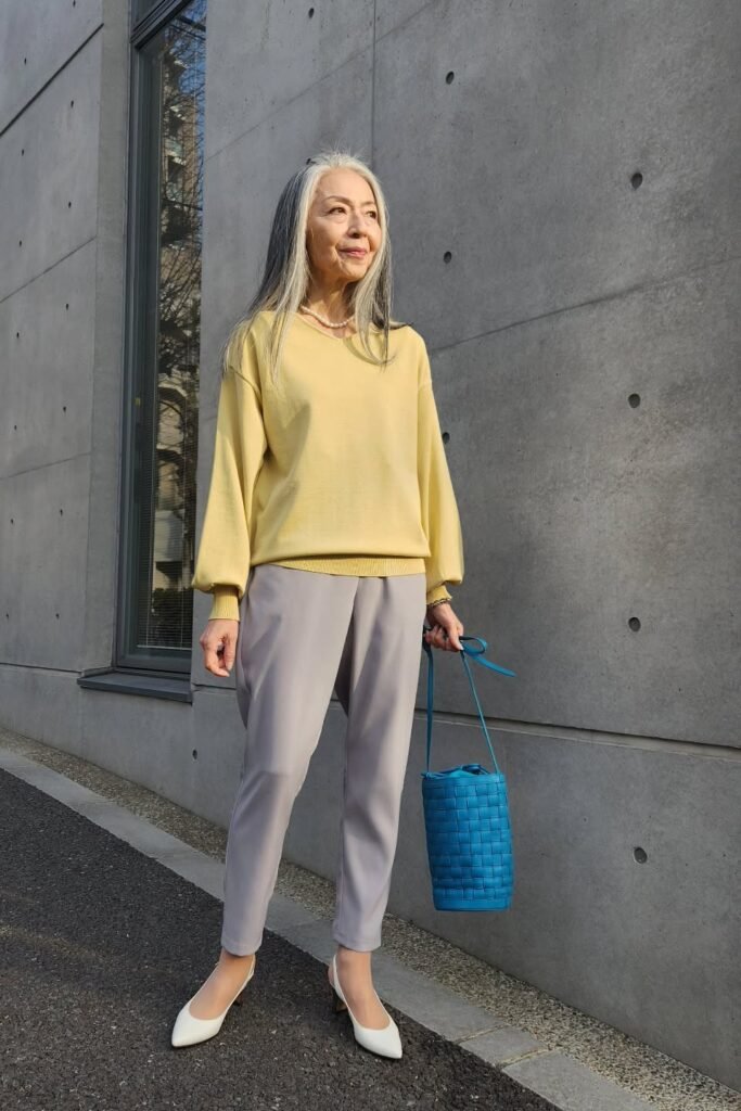 Pale Yellow V-Neck Sweater + Grey Tapered Trousers + White Pointed Pumps