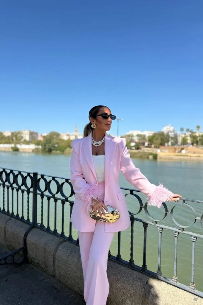 Pink Feather-Trim Blazer + White Square-Neck Top + Matching Pink Tailored Trousers + Black Slim Sunglasses