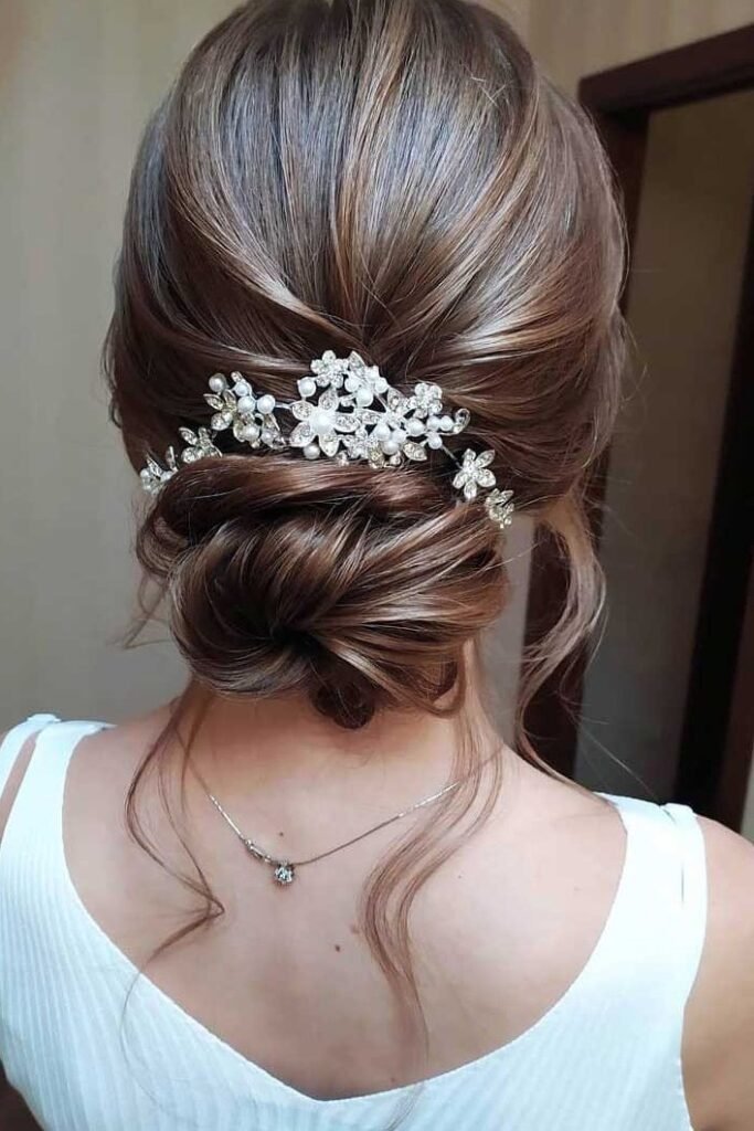Polished Low Twisted Bun with Intricate Silver Flower Clip