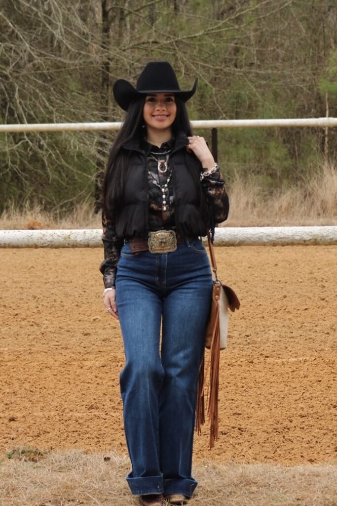 Puffer Vest over Patterned Shirt + Wide Leg Jeans + Black Cowboy Hat