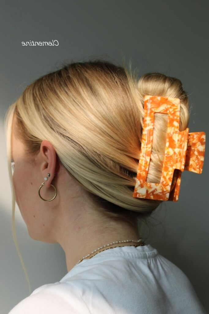 Sleek Low French Roll with Oversized Marble Clip