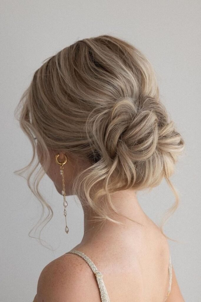 Soft Textured Low Chignon with Long Face-Framing Tendrils