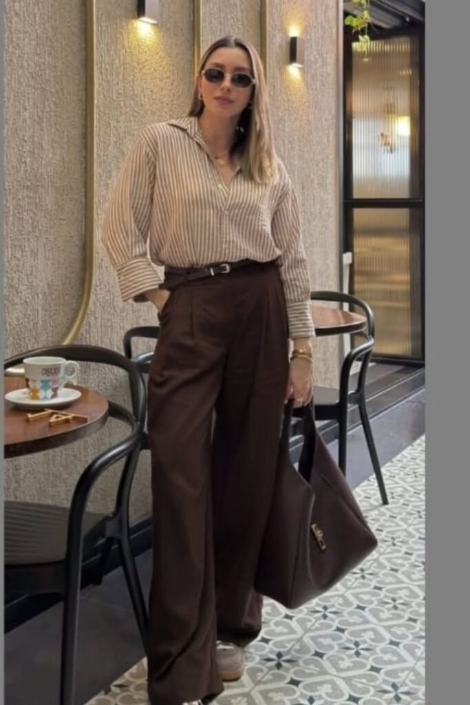 Tan Striped Button-Down Shirt + Dark Brown Pleated Trousers + Grey Sneakers