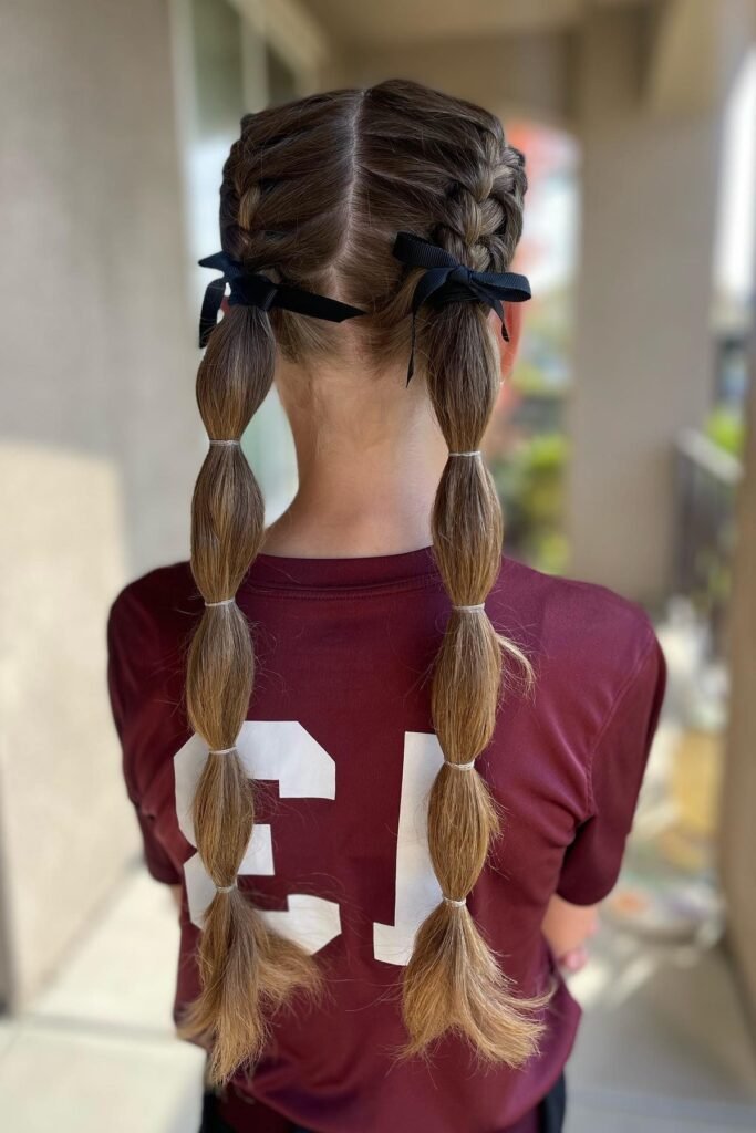 Twin Dutch Braids Transitioning into Sleek Bubble Pigtails