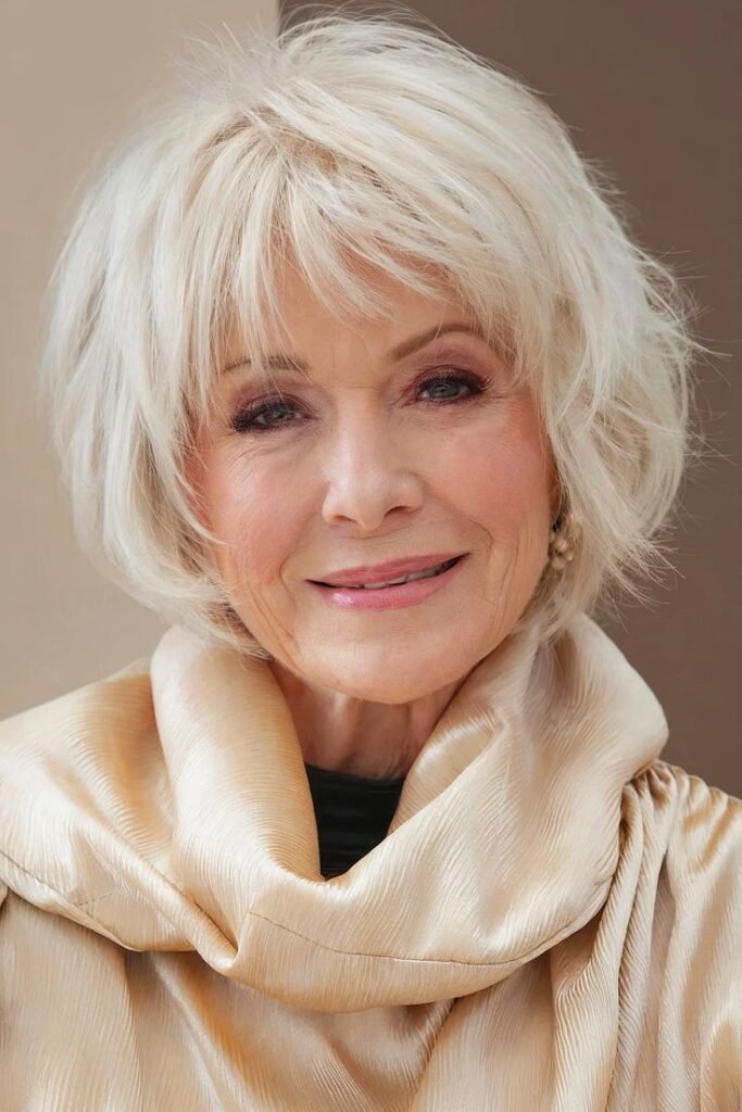 Voluminous Platinum Blonde Shag with Wispy Bangs