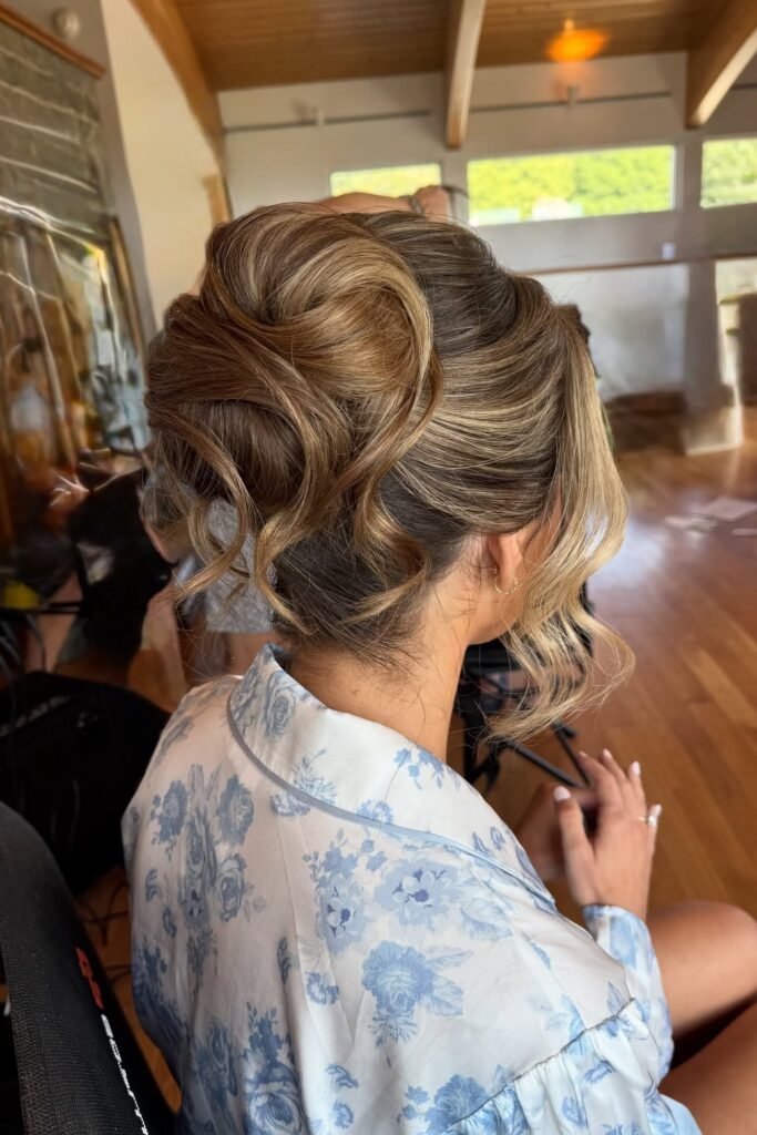 Voluminous Sculpted French Twist with Face-Framing Tendrils