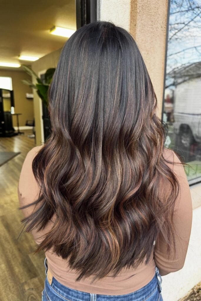 Wavy Brunette Hair with Subtle Copper Balayage