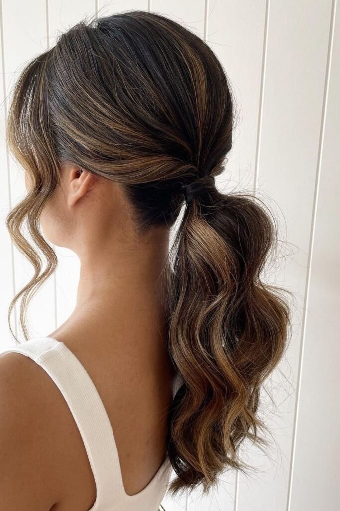 Wavy Brunette Ponytail with Loose Tendrils