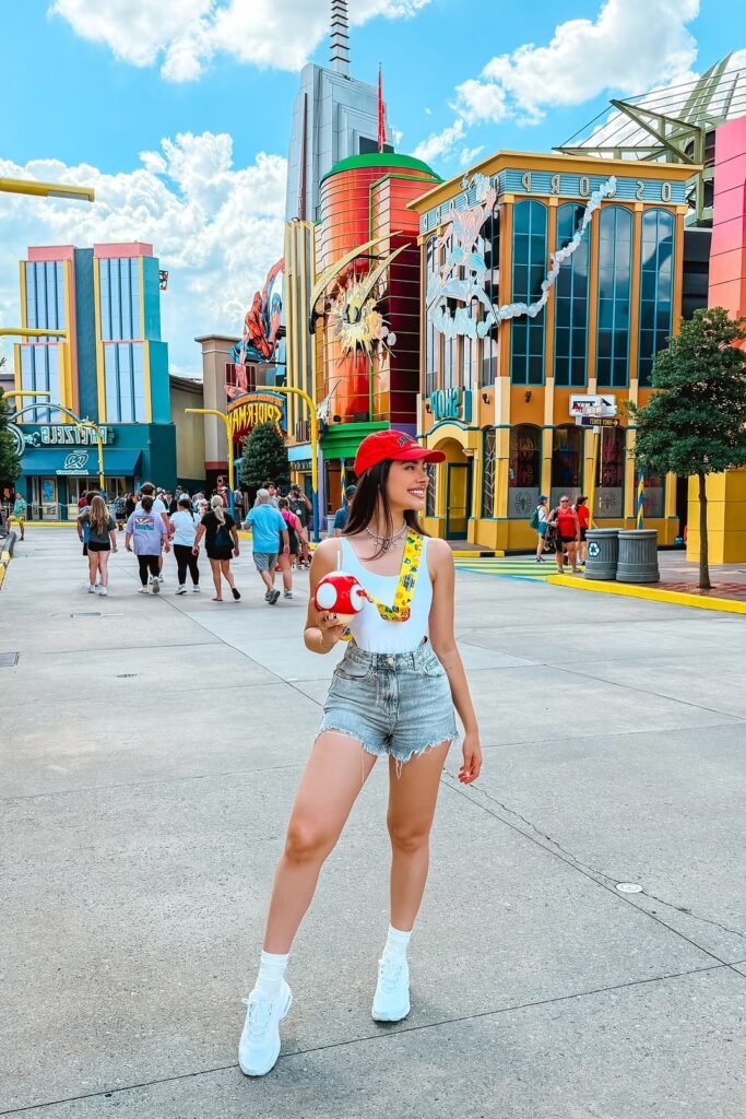 White Bodysuit + Light Wash Denim Shorts + White Sneakers + Red Baseball Cap