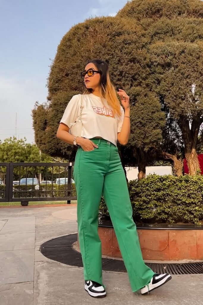 White Graphic Crop Top + Bright Green Straight-Leg Jeans + Black and White Sneakers