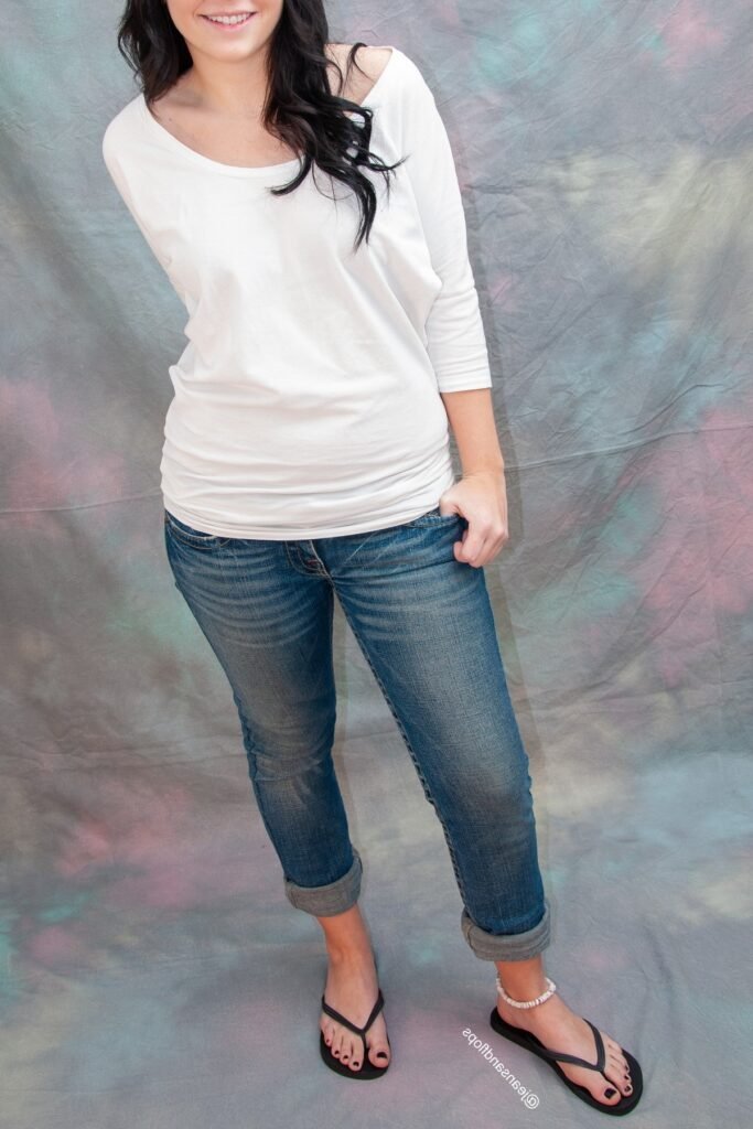 White Off-the-Shoulder Long-Sleeve Top + Rolled-Up Skinny Jeans + Black Flip Flops