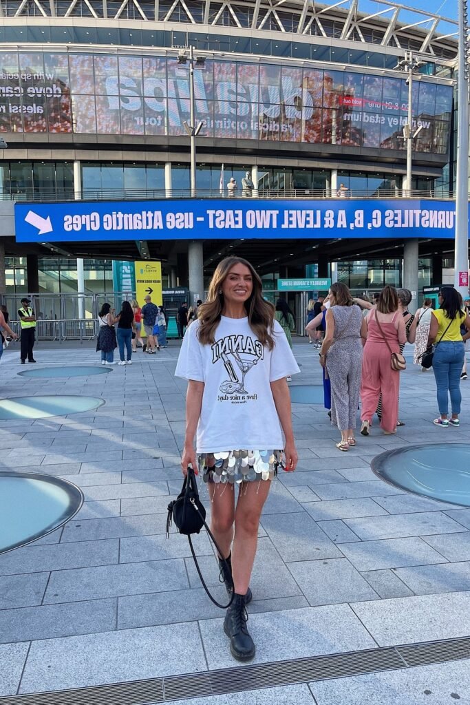 White Oversized Graphic T-Shirt + Silver Sequin Mini Skirt + Black Lace-Up Boots