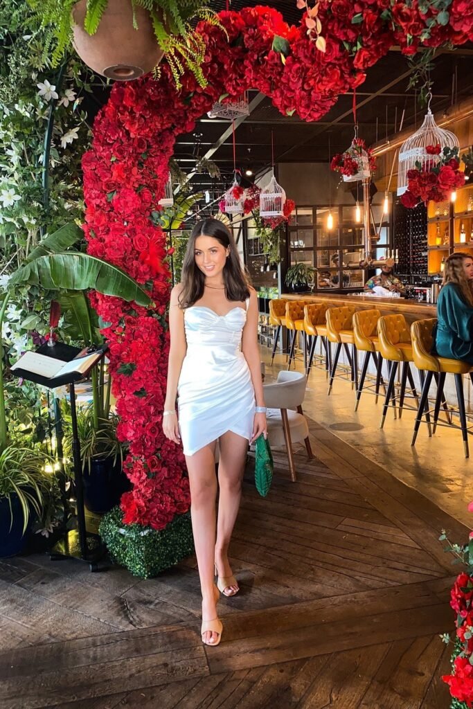 White Satin Sleeveless Ruched Bodycon Mini Dress + Nude Square-Toe Heeled Slides + Green Woven Clutch Bag