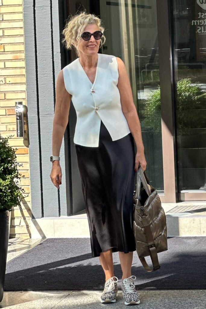 White Sleeveless Button-Up Vest + Black Satin Midi Skirt + Leopard Print Sneakers + Olive Puffy Tote