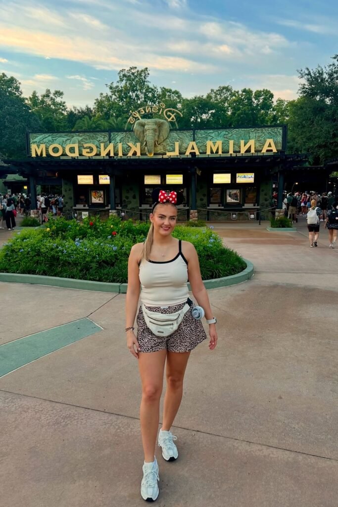 White Tank Top with Black Trim + Leopard Print Shorts + White Fanny Pack + White Sneakers