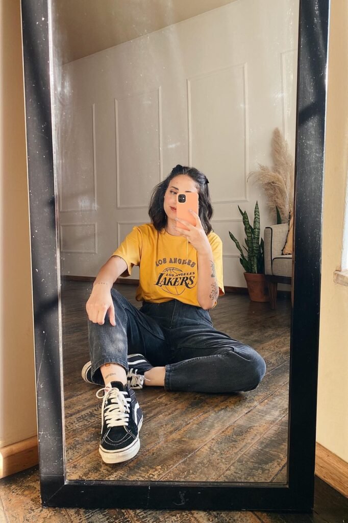 Yellow Graphic T-Shirt + Black High-Waisted Jeans + Black and White High-Top Sneakers