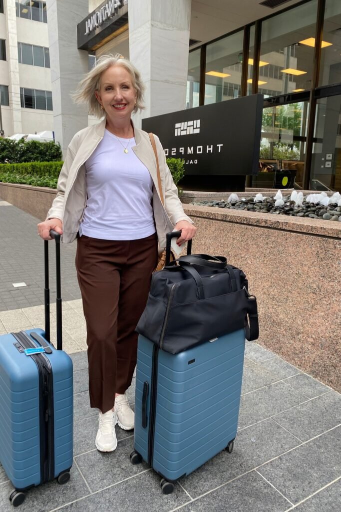 Beige Bomber Jacket + White T Shirt + Dark Brown Trousers + White Sneakers