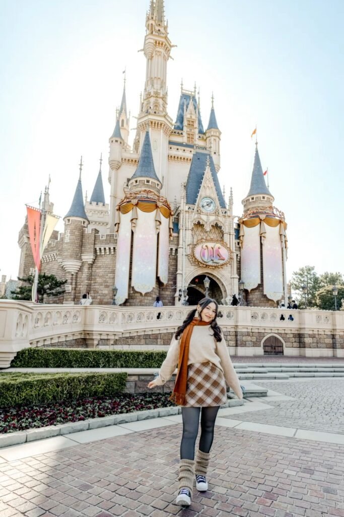 Beige Oversized Sweater + Brown Plaid Mini Skirt + Orange Scarf + Black Sneakers with Leg Warmers