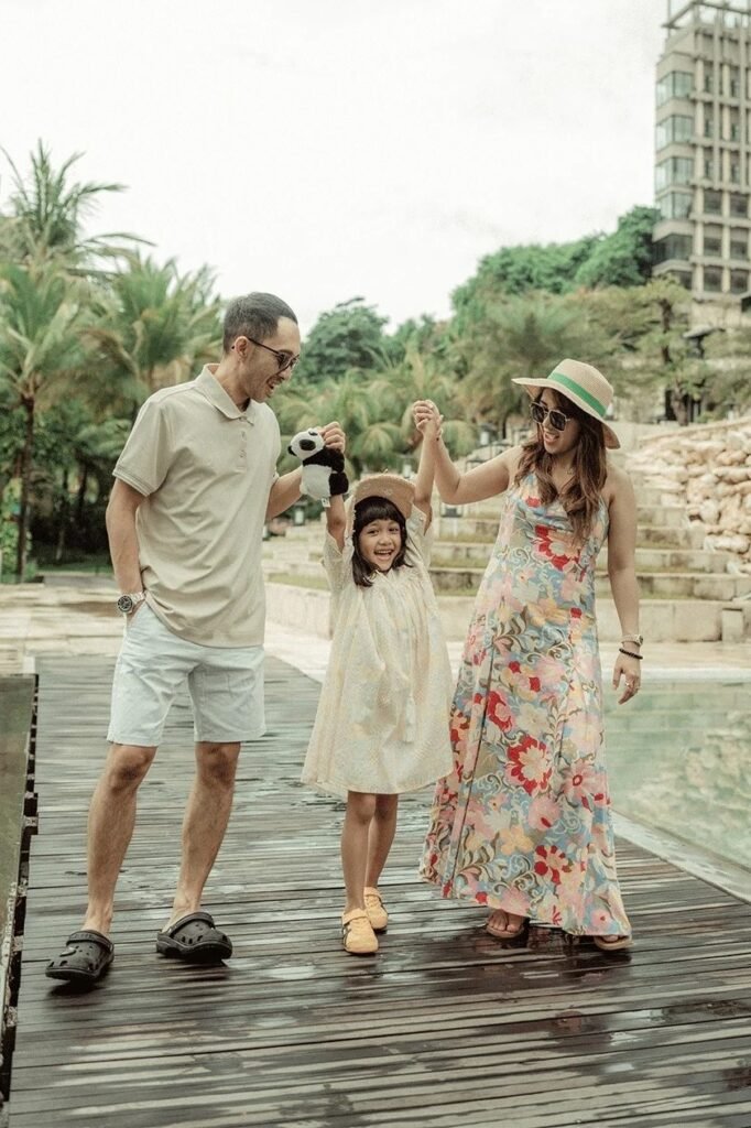 Beige Polo + White Shorts + Black Crocs + Cream Dress + Tan Hat + Floral Maxi Dress + Flat Sandals