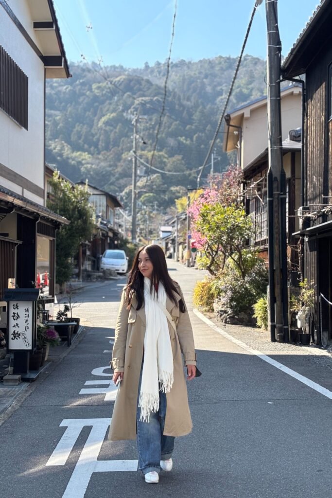 Beige Trench Coat + White Scarf + Wide Leg Blue Jeans + White Sneakers