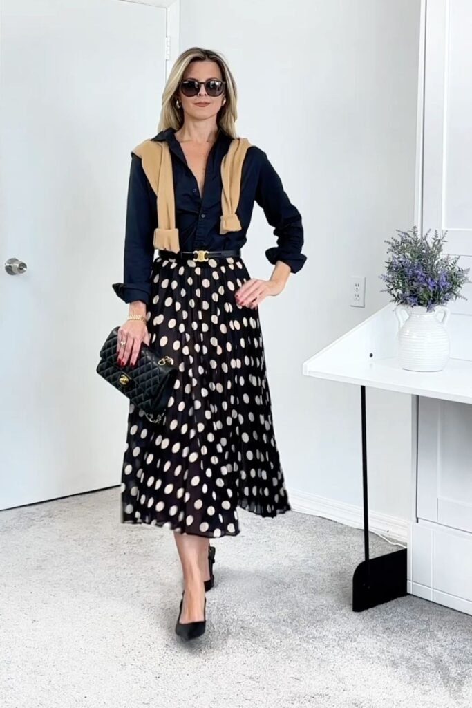 Black Button Down Shirt + Tan Sweater (over shoulders) + Black Polka Dot Pleated Midi Skirt + Black Pumps