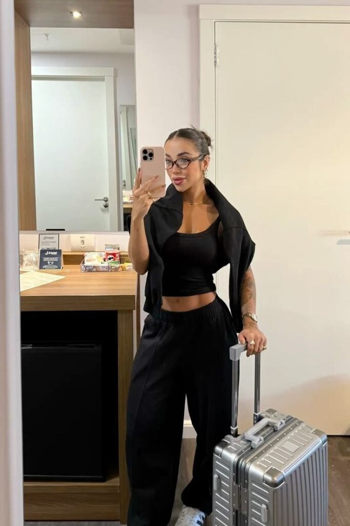 Black Cropped Tank Top + Black High Waisted Sweatpants + Black Zip Up Hoodie Over the Shoulders + White Sneakers