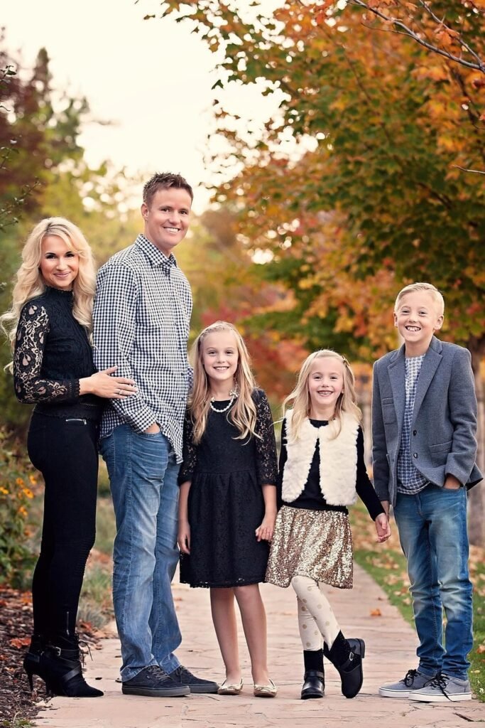 Black Lace Long Sleeve Top + Black Skinny Jeans + Black Heeled Booties (Mother) / Navy Blue Gingham Button Down Shirt + Blue Jeans + Black Sneakers (Father) / Black Lace Dress + Gold Flats (Daughter) / Black Top + Gold Sequin Skirt + Patterned Leggings + Black Flats (Daughter) / Grey Blazer + Plaid Shirt + Blue Jeans + White Sneakers (Son)