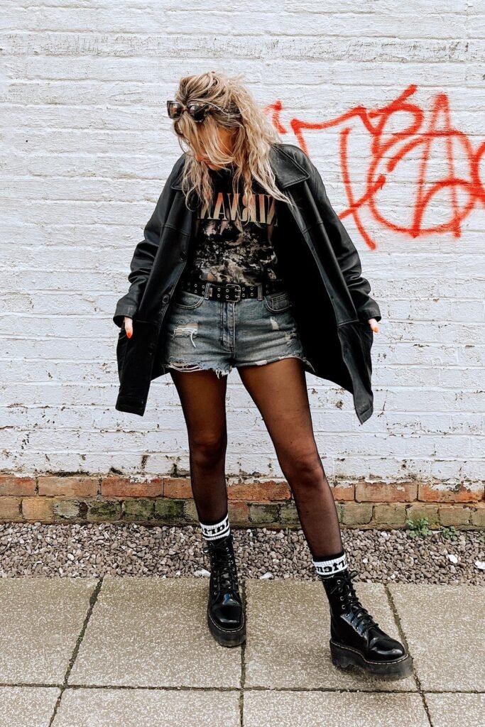 Black Leather Jacket + Graphic T Shirt + Distressed Denim Shorts + Black Tights + Platform Boots
