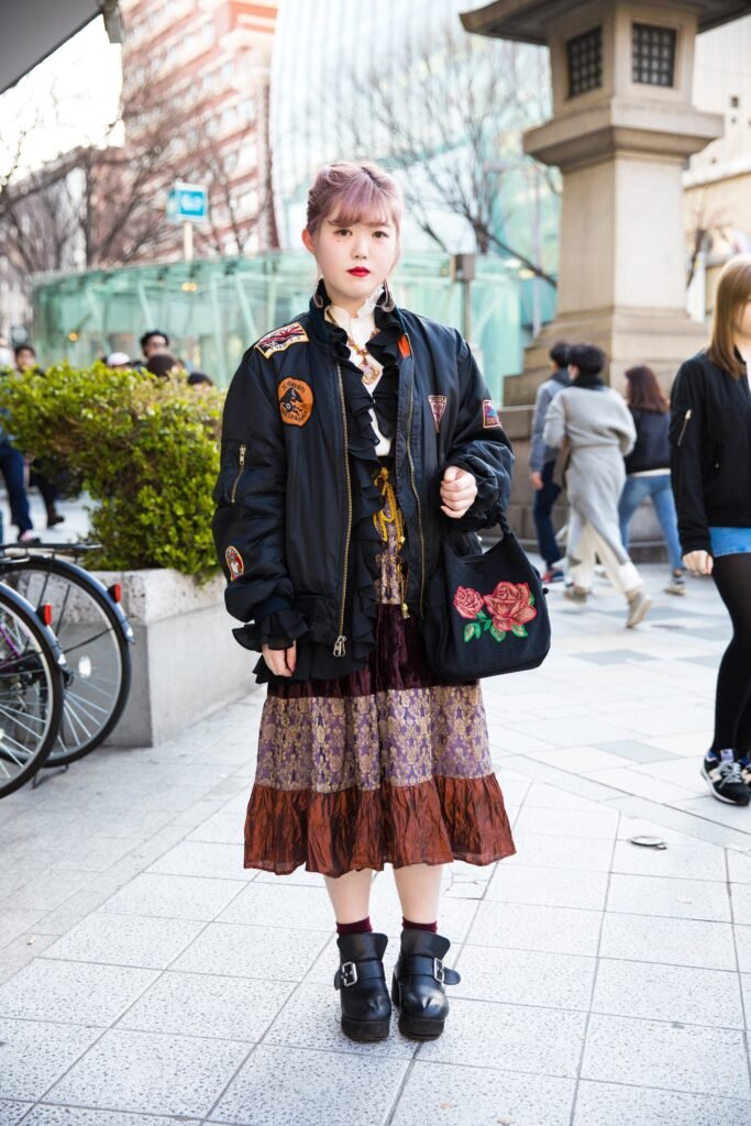 Black Patch Adorned Bomber Jacket + Tiered Purple & Brown Brocade Skirt + Black Ankle Boots