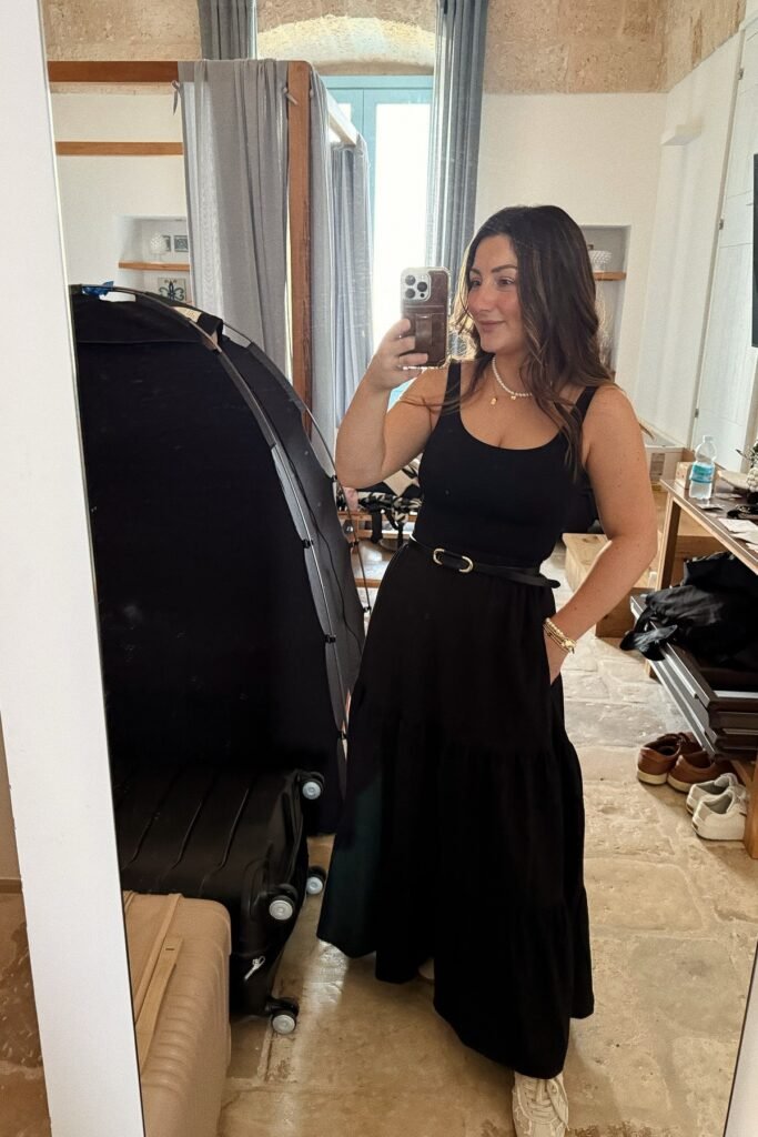 Black Scoop Neck Tank Top + Black Tiered Maxi Skirt + Thin Black Belt with Gold Buckle + Layered Pearl Necklaces + White Sneakers