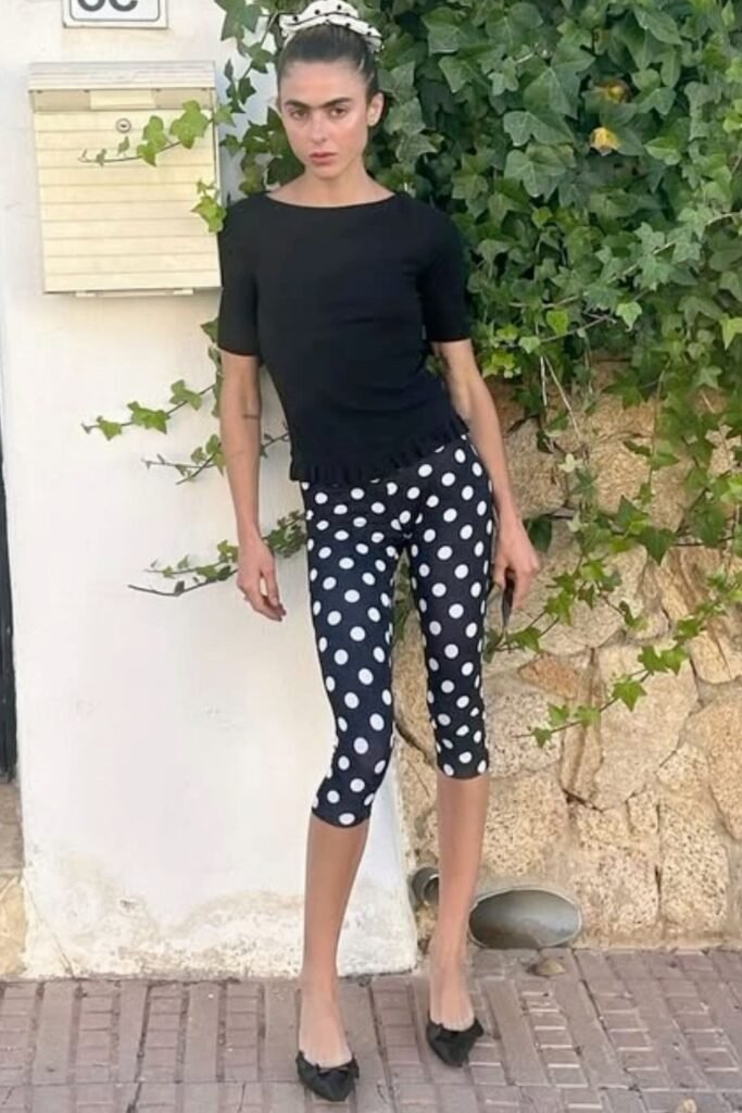 Black Short Sleeve Ruffle Hem Top + Black and White Polka Dot Leggings + Black Pointed Flats