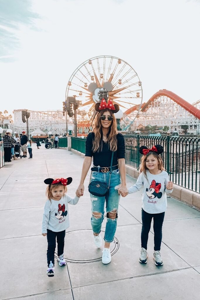 Black Short Sleeve Top + Distressed Blue Jeans + White Sneakers