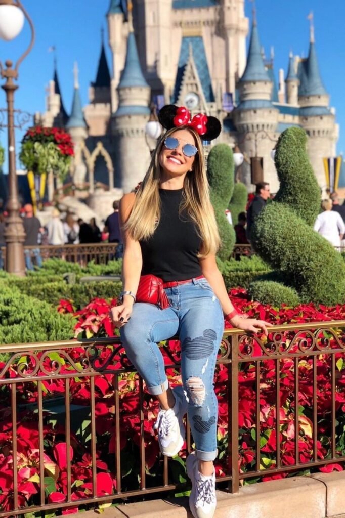Black Sleeveless Mock Neck Top + Distressed Light Wash Jeans with Mickey Patches + White Sneakers