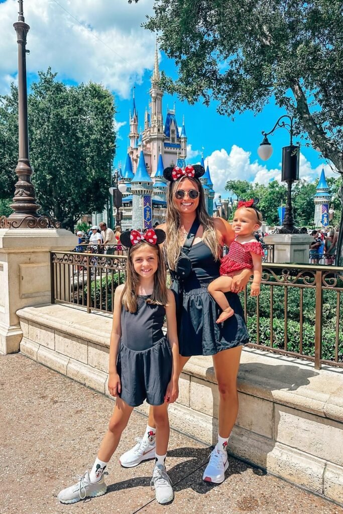 Black Sleeveless Romper + Mickey Mouse Crew Socks + White Sneakers