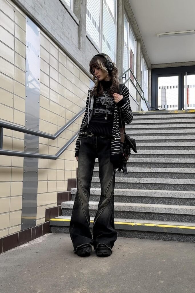 Black Striped Zip Up Hoodie + Black Graphic Top + Distressed Grey Flared Jeans + Chunky Black Sneakers