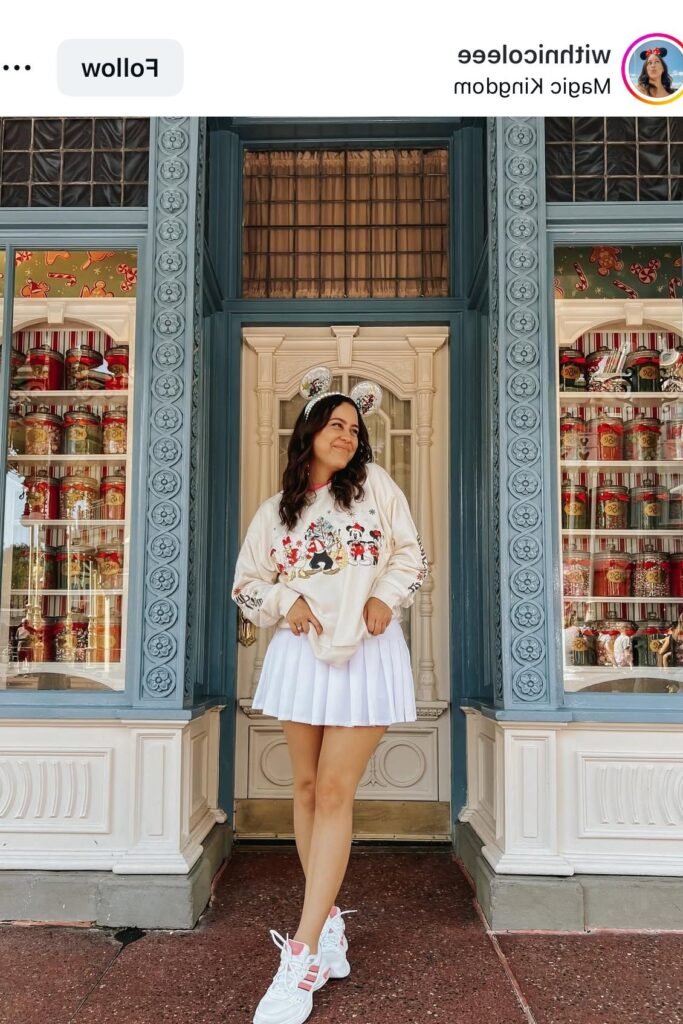 Cream Disney Holiday Sweatshirt + White Pleated Mini Skirt + White and Pink Sneakers